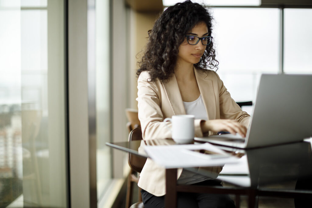 A woman working at a computer.