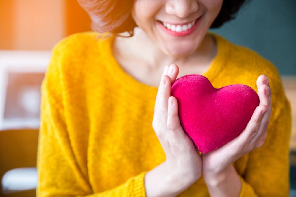 A woman holding a heart