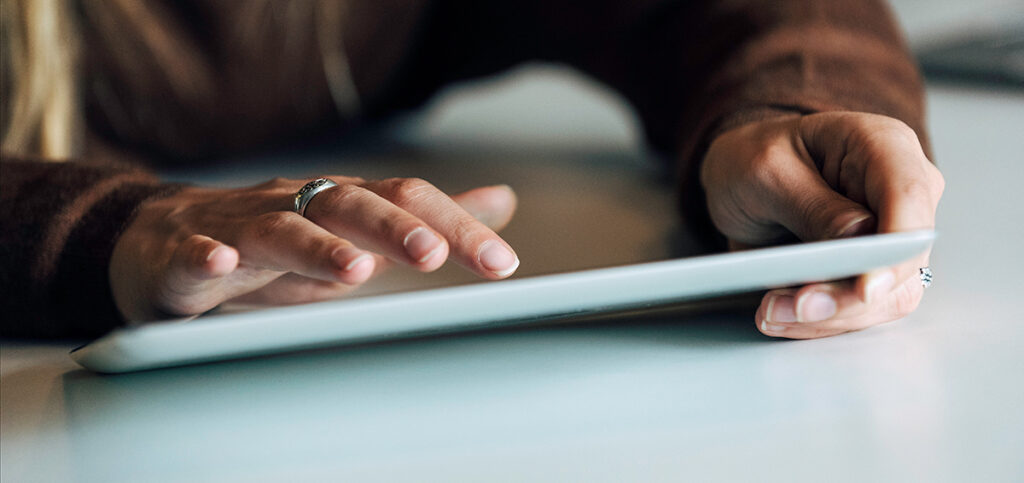 Someone typing on a tablet